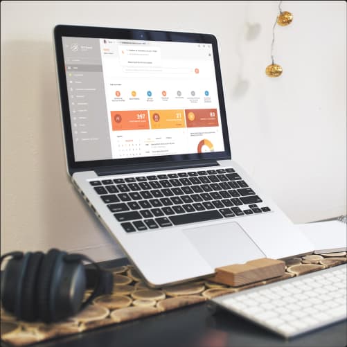 IDS company platform displayed on a laptop. Laptop displaying the IDS company platform on a workspace. The screen shows a dashboard with various graphs and performance indicators.